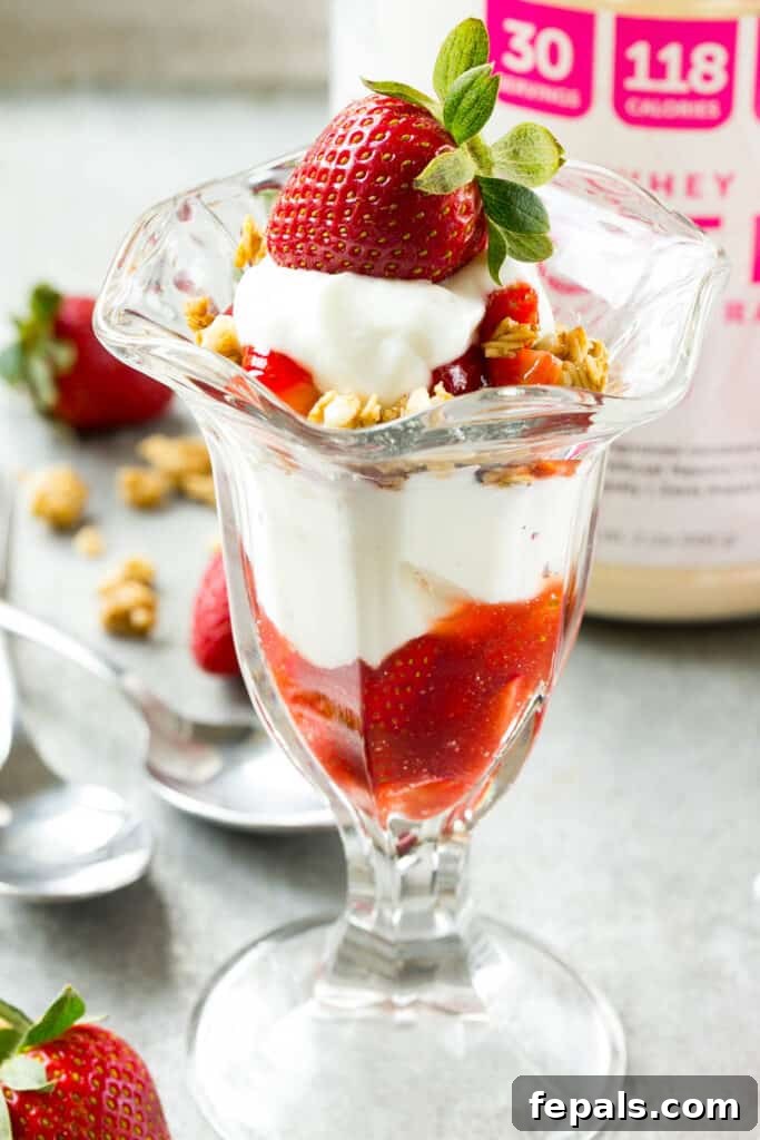Strawberry Parfait Perfection 5 side shot of a cup of strawberry parfait topped with a fresh strawberry