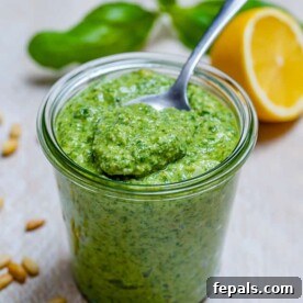 Garden Fresh Pesto Bliss 11 side shot of homemade pesto in a jar with a spoon full of pesto