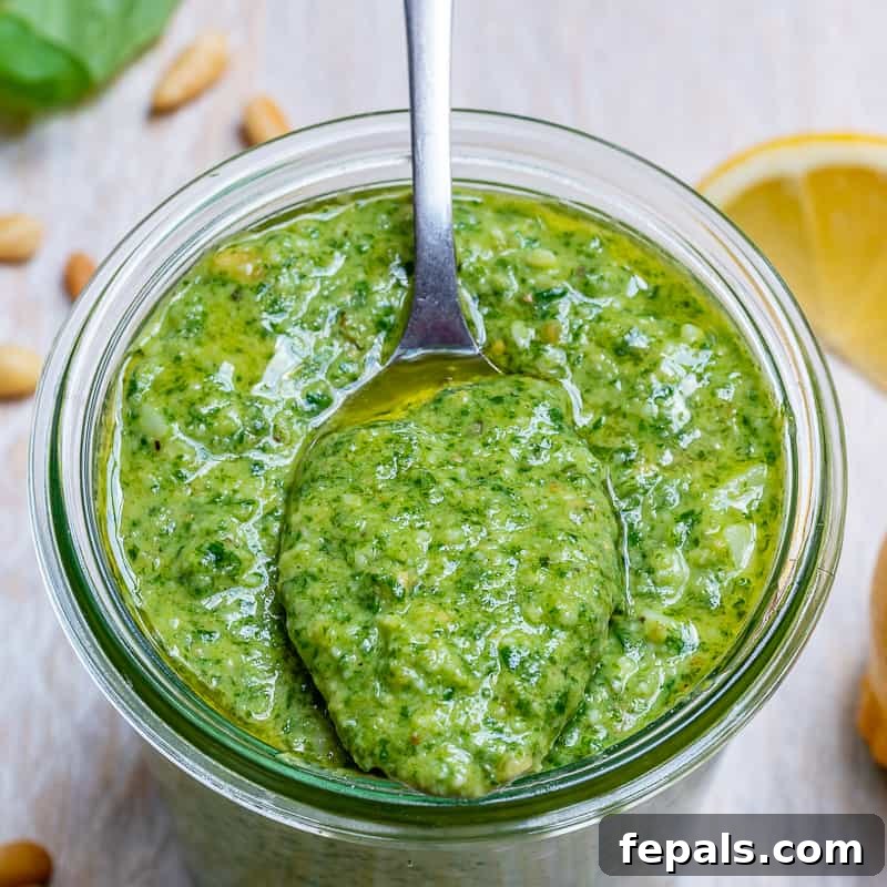 Garden Fresh Pesto Bliss 7 close up a jar of pesto sauce with a spoonful of pesto