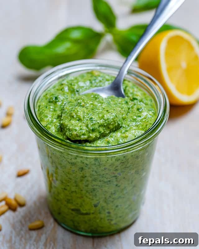 Garden Fresh Pesto Bliss 8 side shot of homemade pesto in a jar with a spoon full of pesto