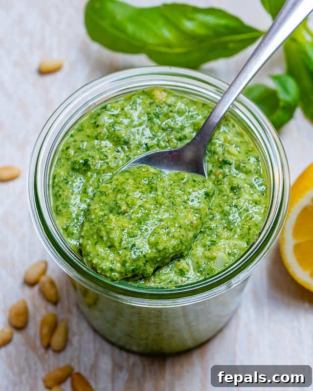Garden Fresh Pesto Bliss 9 spoon full of pesto sauce in the jar of pesto sauce