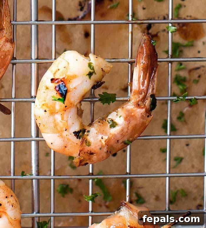Best Grilled Shrimp Recipe Plated Honey Lemon Shrimp with a side of fresh herbs and lemon wedges