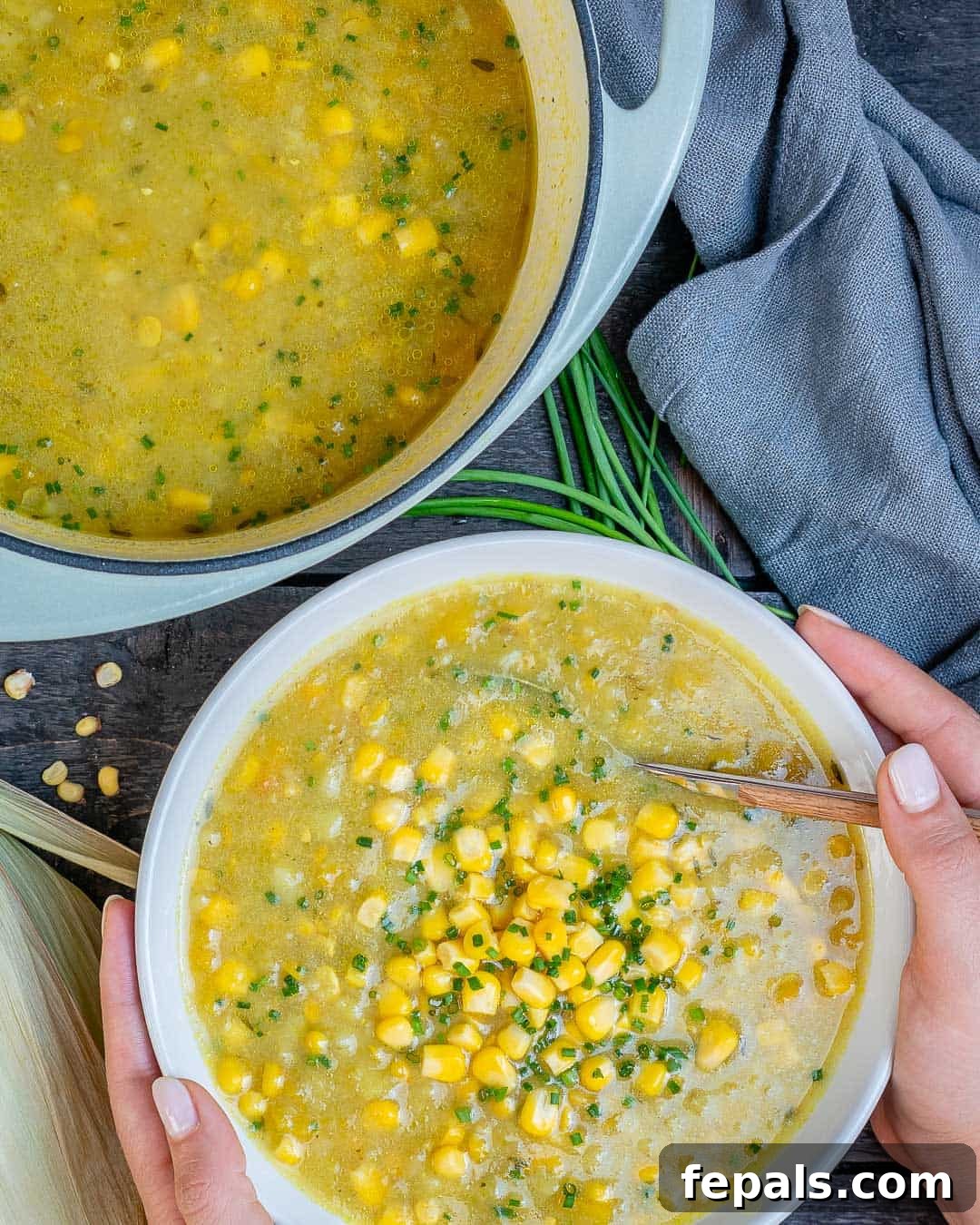 Wholesome Sweet Corn Chowder 2 Healthy Summer corn chowder in a bowl garnished with fresh chives