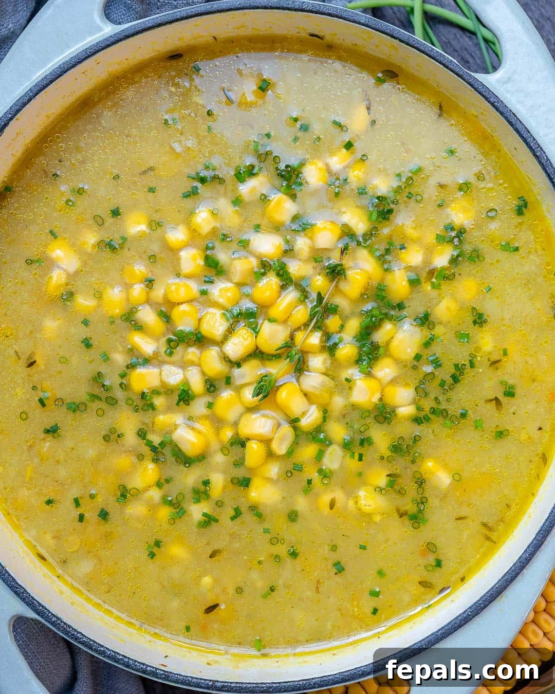 Wholesome Sweet Corn Chowder 3 Overhead shot of Healthy Summer corn chowder in a rustic bowl with a spoon