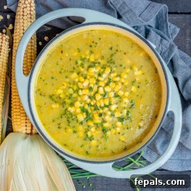 Corn soup in a round white pot.