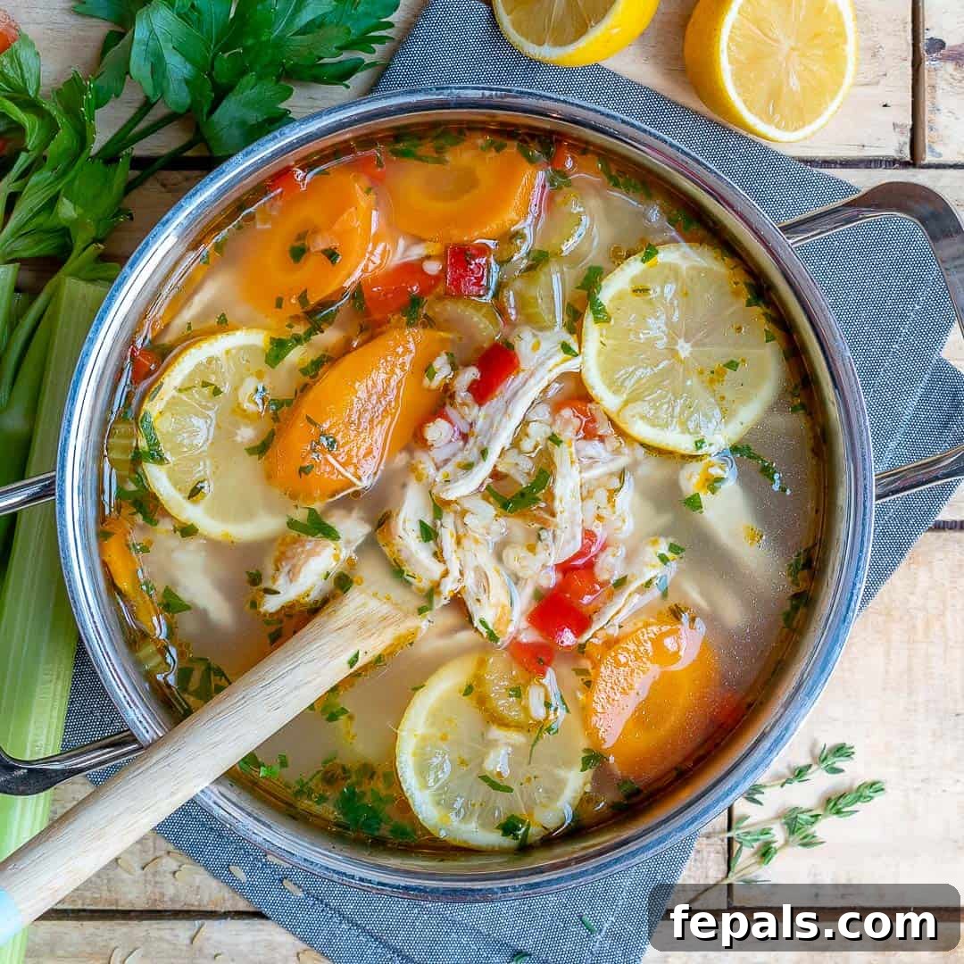 An inviting overhead view of a large pot filled with fragrant Lemon Chicken Rice Soup, ready for serving.