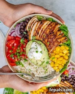 top view of hand holding a bowl Grilled Chicken Burrito Bowl