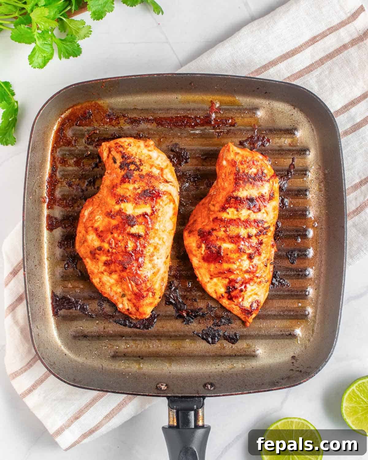 Fiesta Chicken Bowl 4 Two cooked chicken breasts on a grill pan.