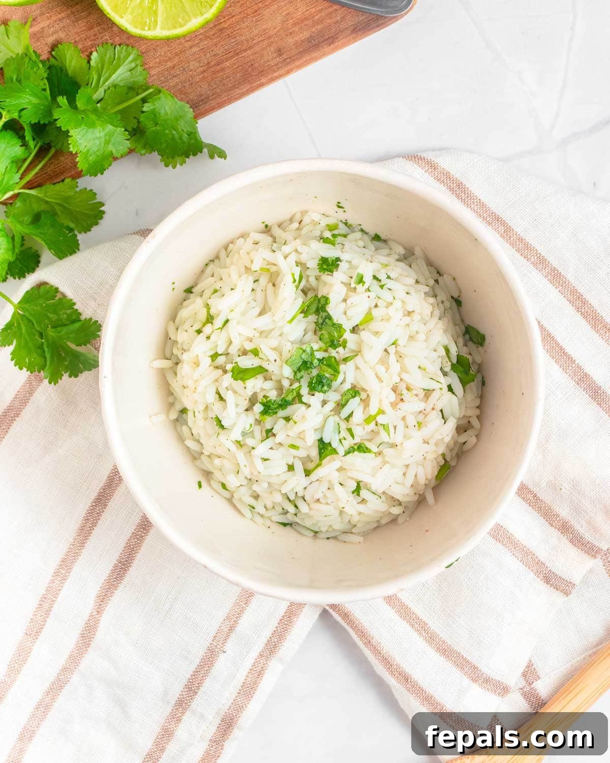 Fiesta Chicken Bowl 6 Cooked rice mixed with chopped cilantro and lime in a bowl.