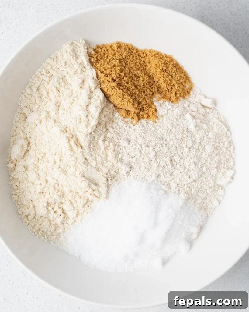 Wholesome Ready-to-Eat Cookie Dough 5 oat flour, coconut flour, almond flour, sweetener added to a bowl