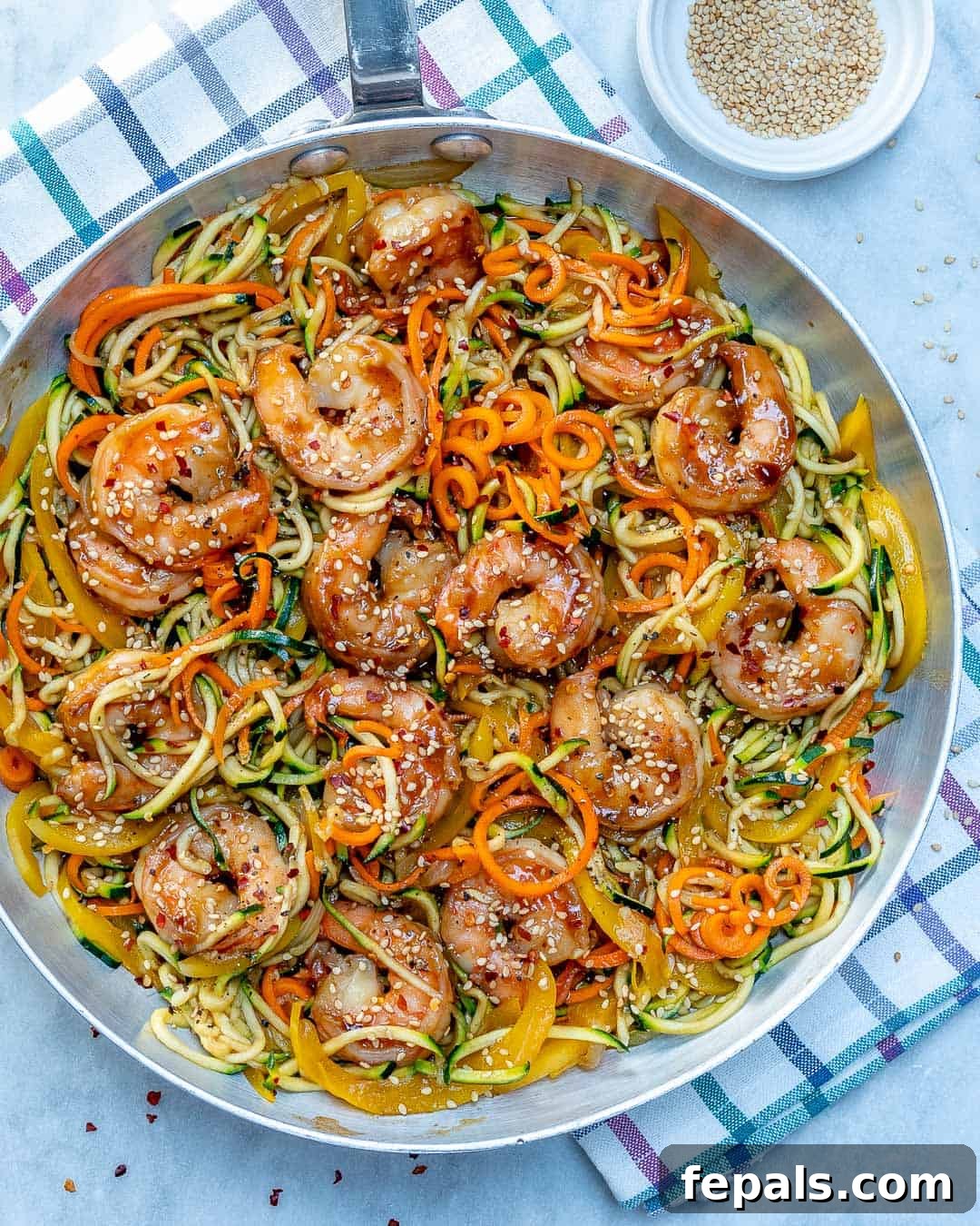 Vibrant Asian Shrimp Zoodle Stir-fry 2 Delicious Asian shrimp and veggie noodle stir-fry served in a bowl