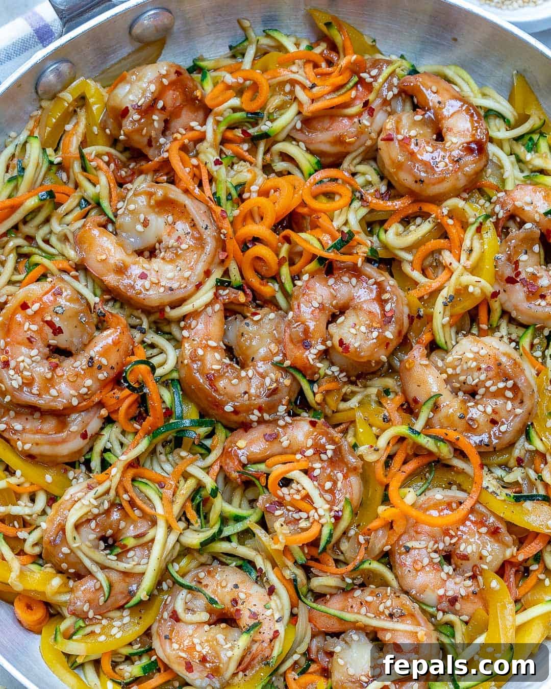 Vibrant Asian Shrimp Zoodle Stir-fry 3 Close-up of seared shrimp and zucchini noodles in a pan before sauce is added