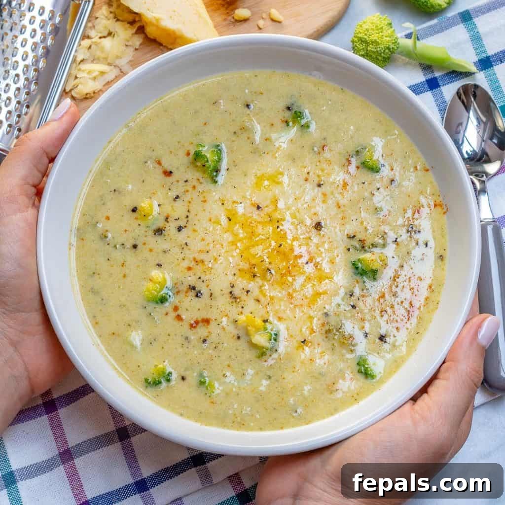 Wholesome Broccoli Cheddar Bliss 2 hand holding a bowl of healthy Broccoli cheddar Soup