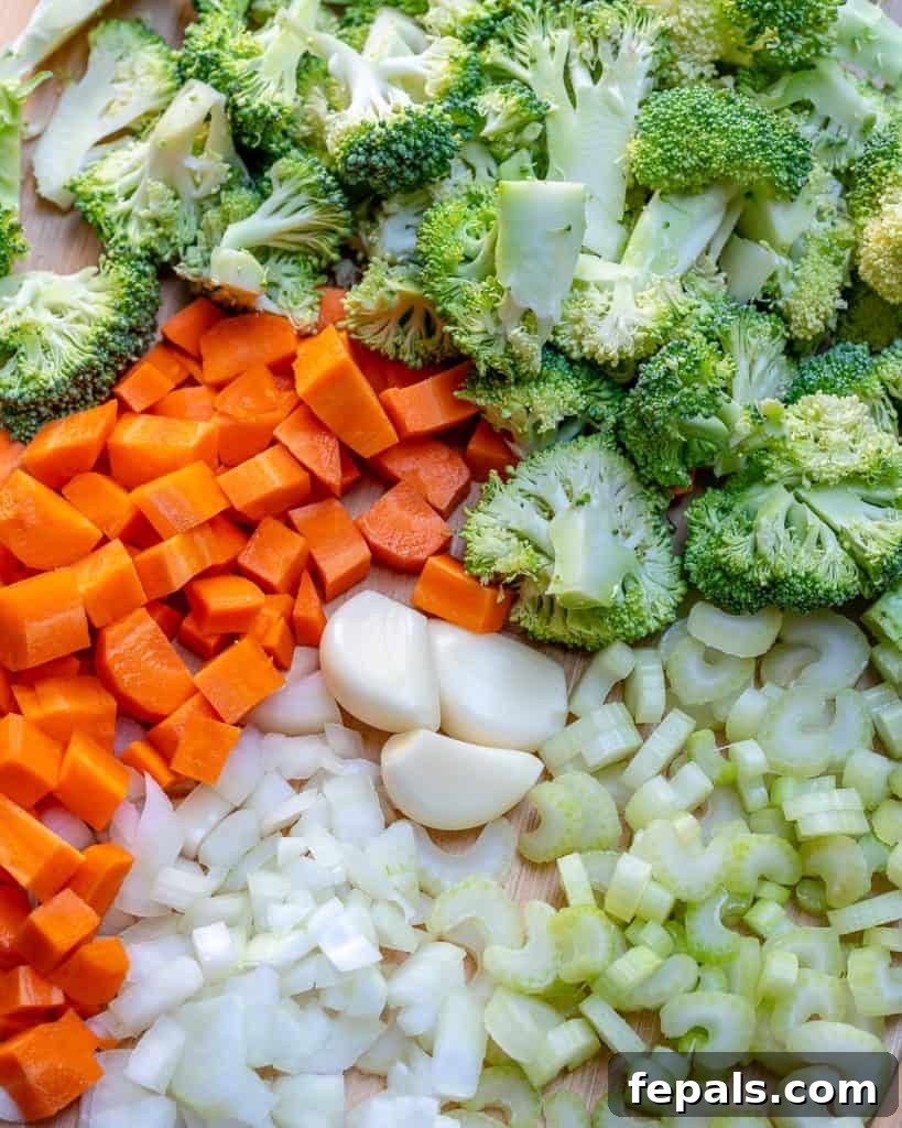 Wholesome Broccoli Cheddar Bliss 4 chopped veggies, carrots, broccoli, onion, celery, on a cutting board for Broccoli Cheddar Soup