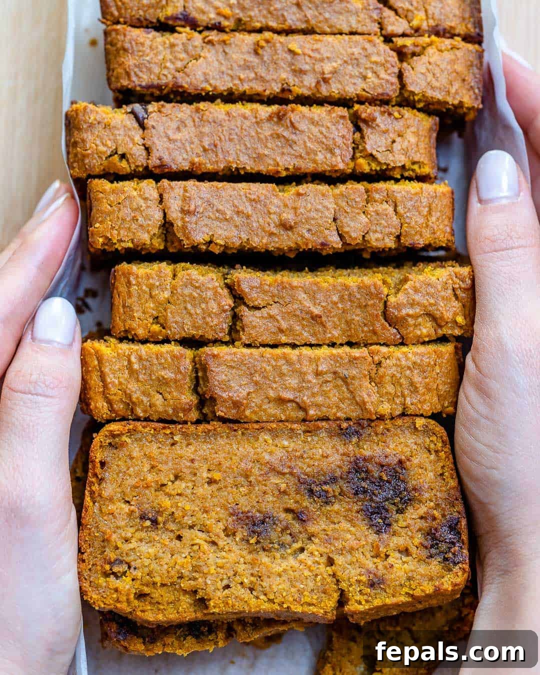 Pumpkin Bread Recipe Hand holding slices of moist Chocolate Chip Pumpkin Bread