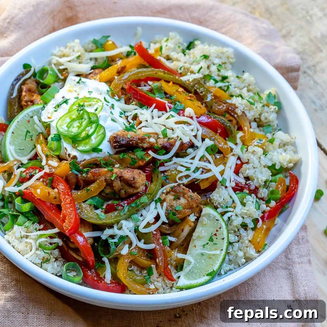 A vibrant and healthy chicken Mexican bowl with various toppings, seen from above.