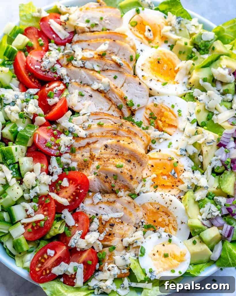 close up view of Cobb salad recipe with sliced grilled chicken and boiled eggs 