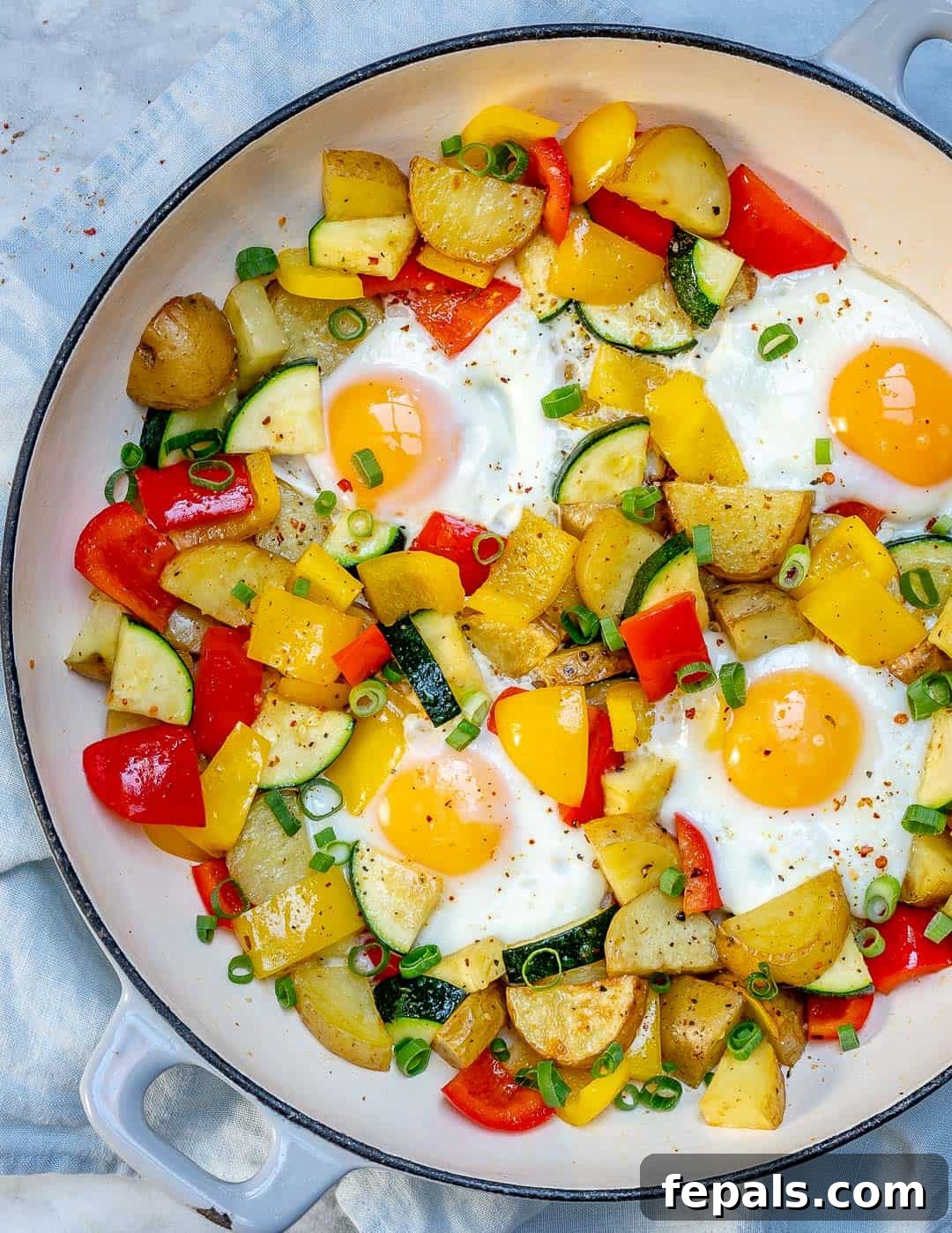 Sunrise Skillet with Eggs and Garden Harvest 5 A vibrant display of eggs and mixed vegetables cooked to perfection in a single pan, ready to be enjoyed.