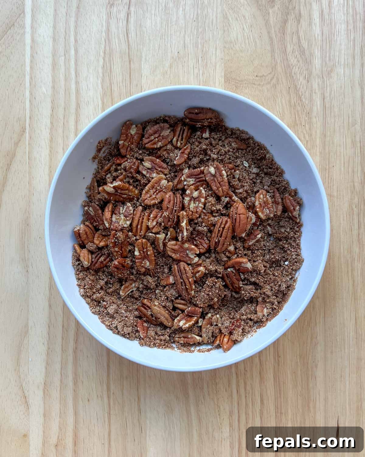 pecans are added over the flour base for the casserole topping. 