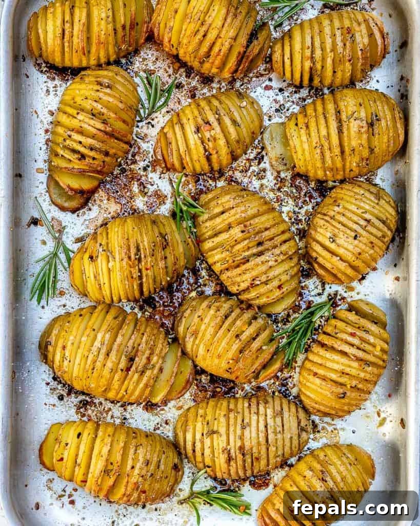 Golden Accordion Potatoes 2 top view of baked Garlic butter Hasselback potatoes on a sheet pan