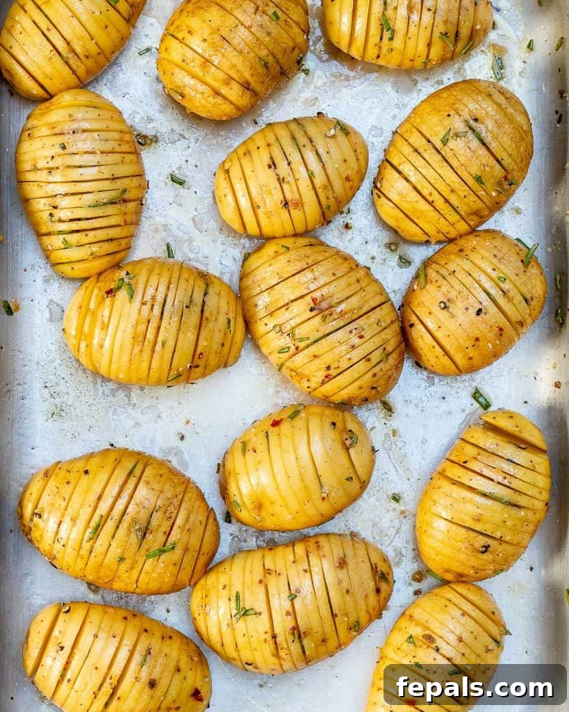 Golden Accordion Potatoes 5 sliced potatoes before baking on a sheet pan