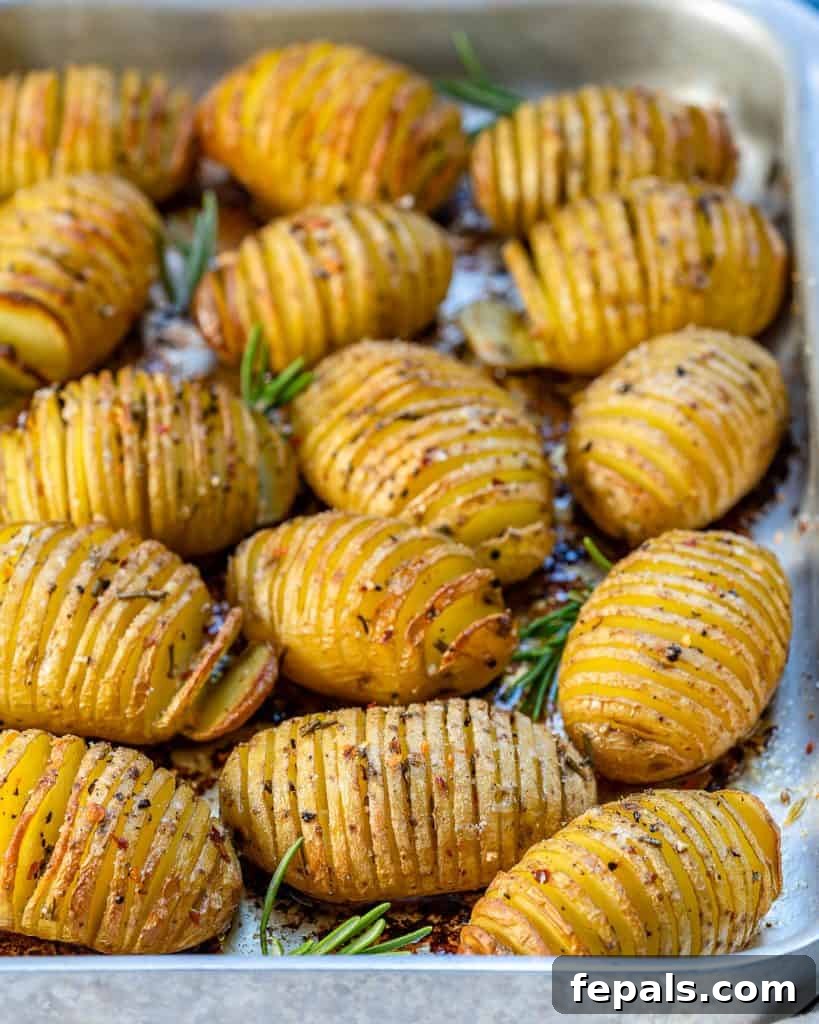 Golden Accordion Potatoes 9 side shot of baked sliced golden potatoes on a sheet pan