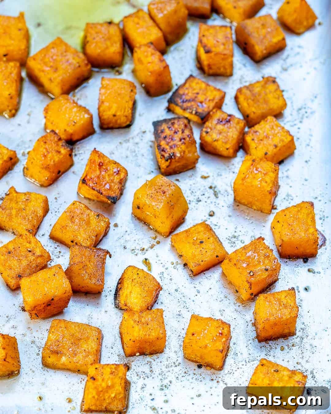 Caramelized Honey Butternut Delight 4 Roasted squash squares on a pan.