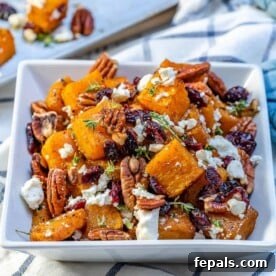 Caramelized Honey Butternut Delight 9 Roasted squash with cranberry, feta cheese, and pecan in a white bowl.