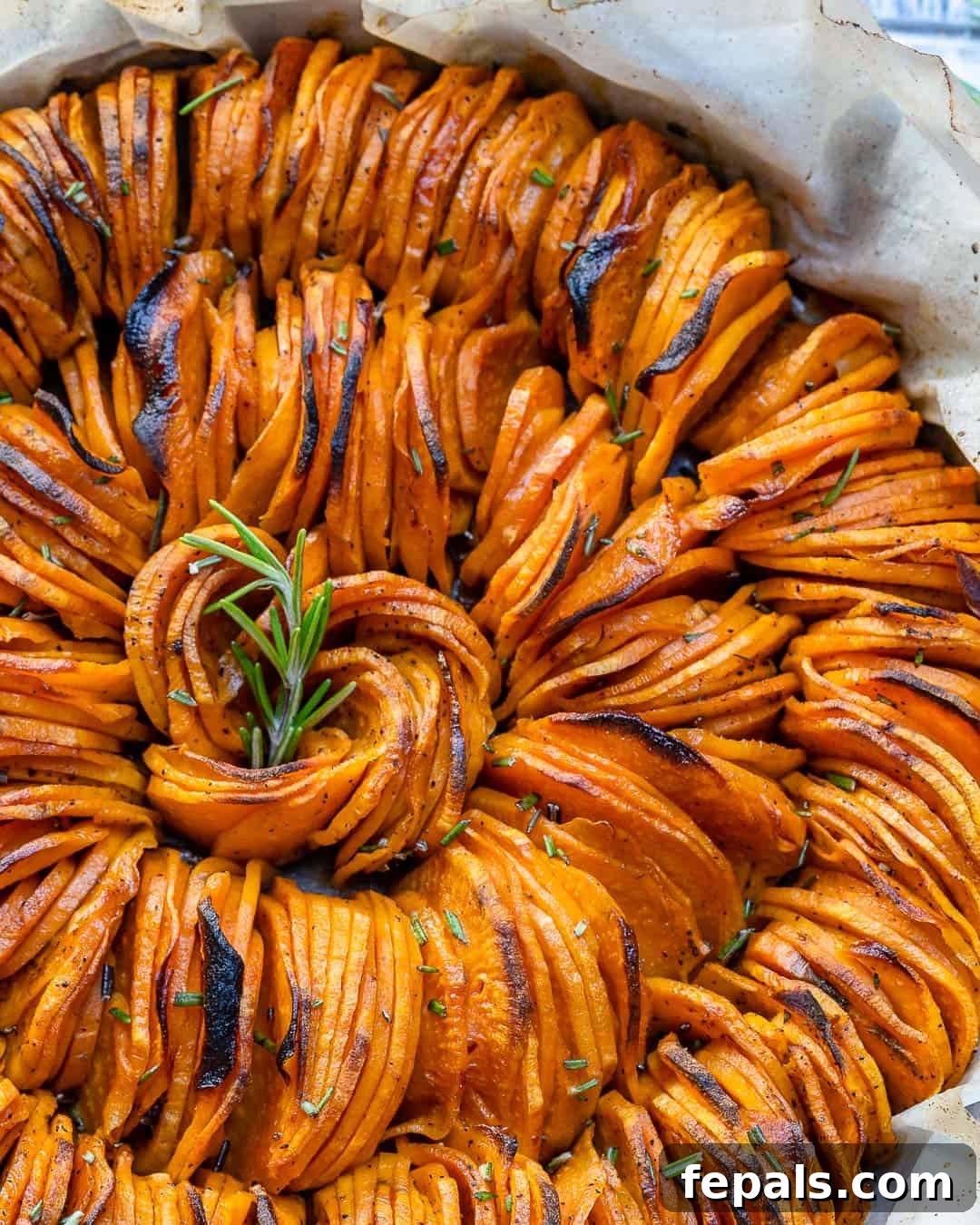 sliced roasted Sweet Potatoes in a baking dish.