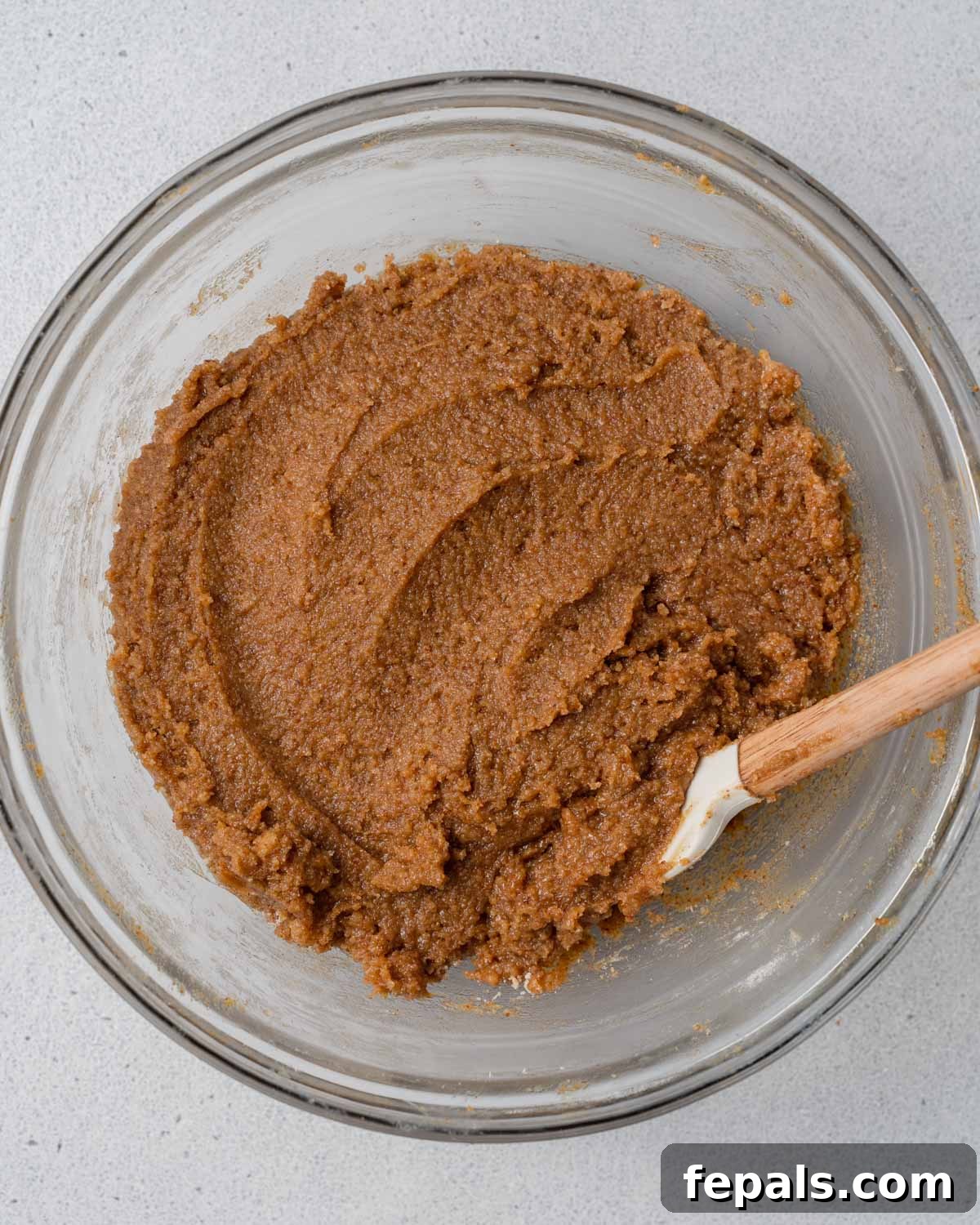 Thick pumpkin bar batter is mixed thoroughly in a bowl.
