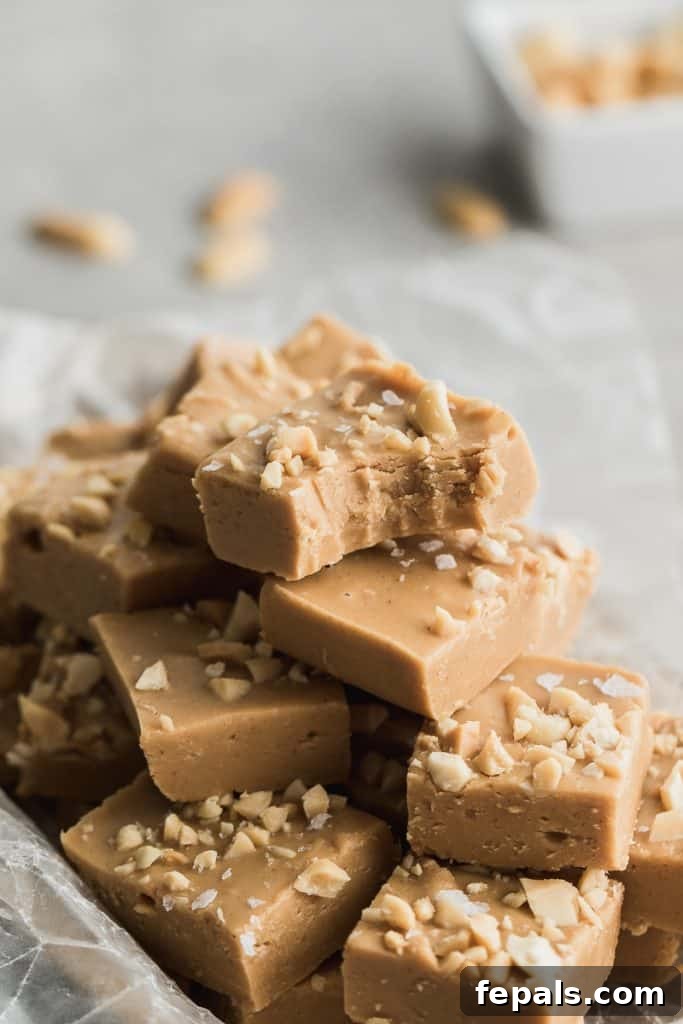 Decadent Peanut Butter Fudge 3 Side shot of precisely cut squares of peanut butter fudge, showcasing its creamy texture.
