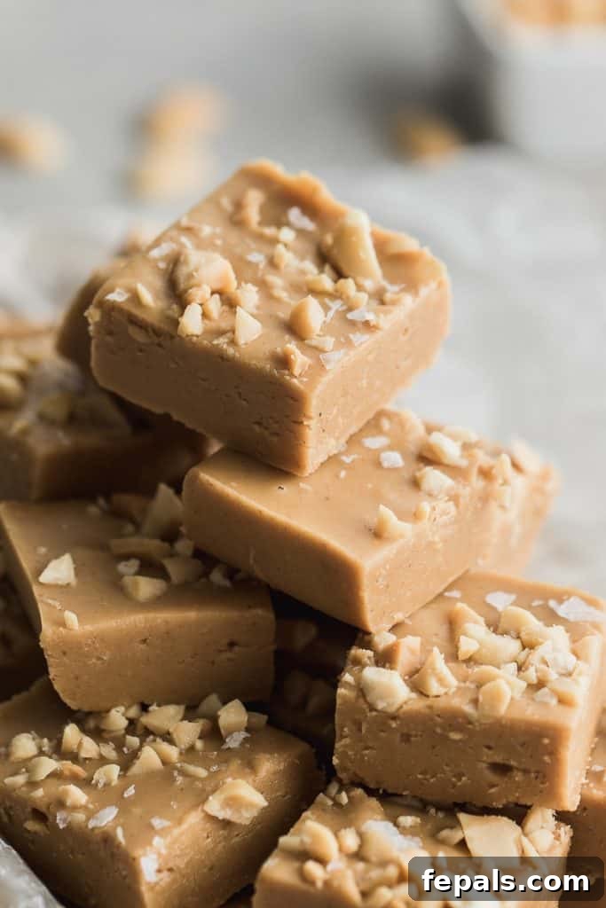 Decadent Peanut Butter Fudge 5 A stack of perfectly crafted peanut butter fudge squares, ready for serving.