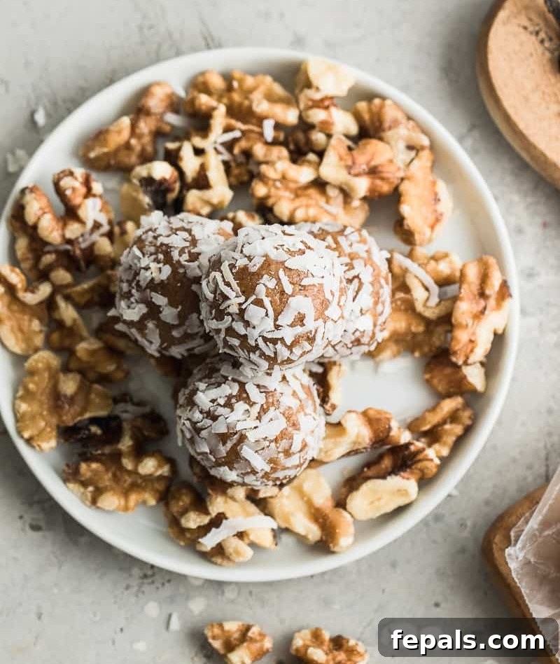 Top view of perfectly round date energy balls arranged on a plate.