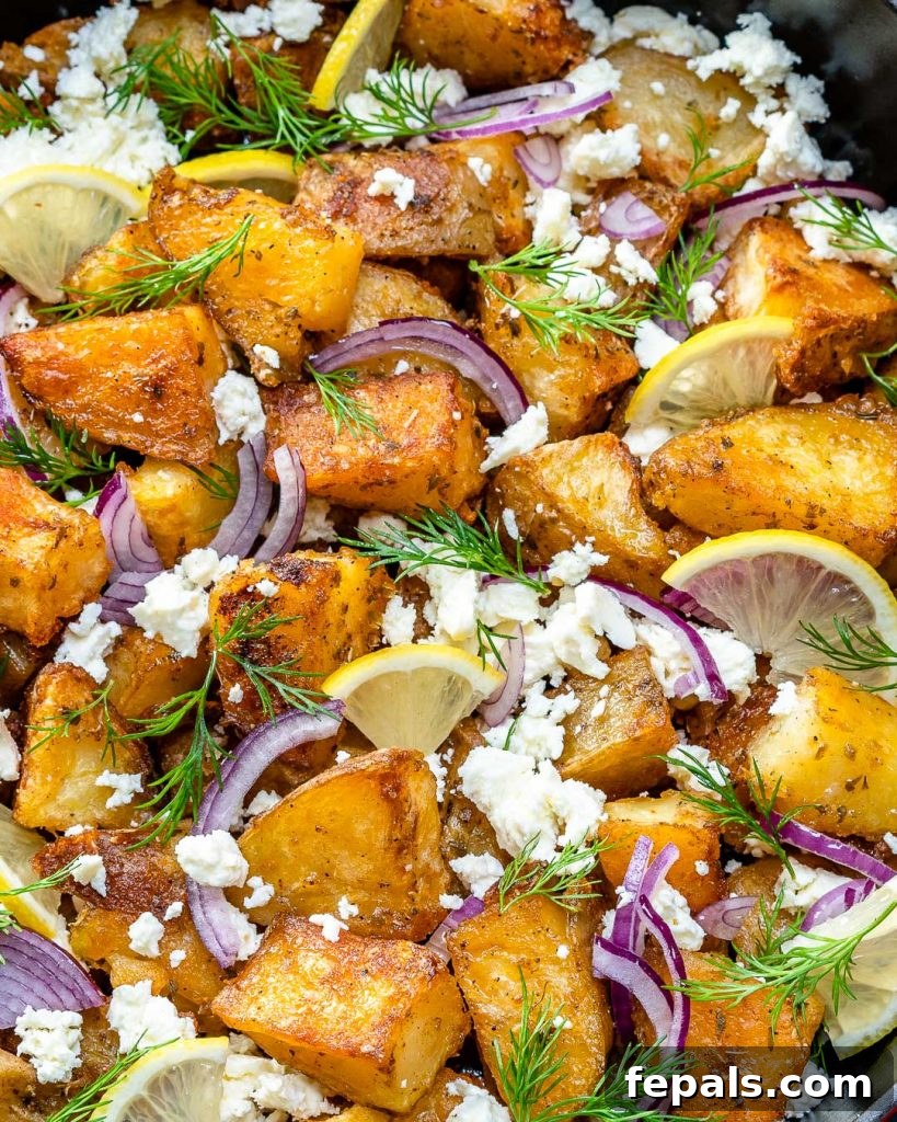 Zesty Greek Roasted Potatoes 5 close up or roasted greek potatoes topped with feta cheese, onion, and fresh dill