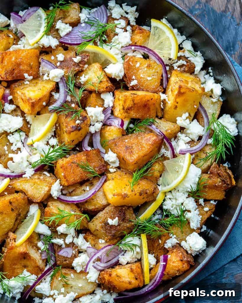 Zesty Greek Roasted Potatoes 7 crispy potatoes loaded with feta, fresh dill, sliced onion, sliced lemons, in a skillet