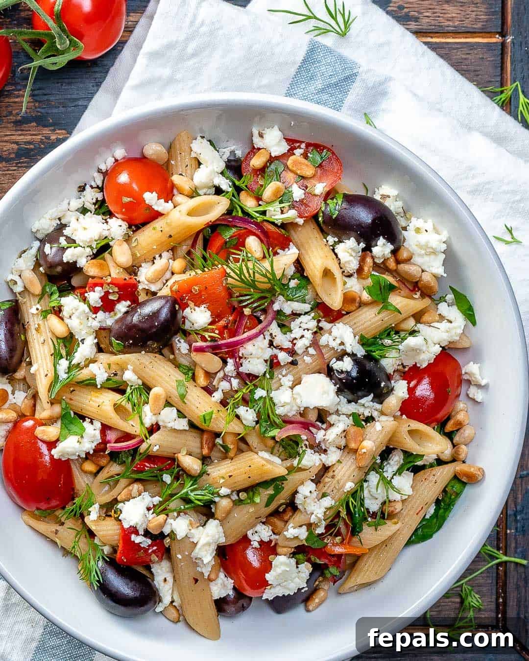 Fresh Greek Cherry Tomato Pasta 2 Greek Cherry Tomato Pasta on a white plate, garnished with fresh herbs and feta