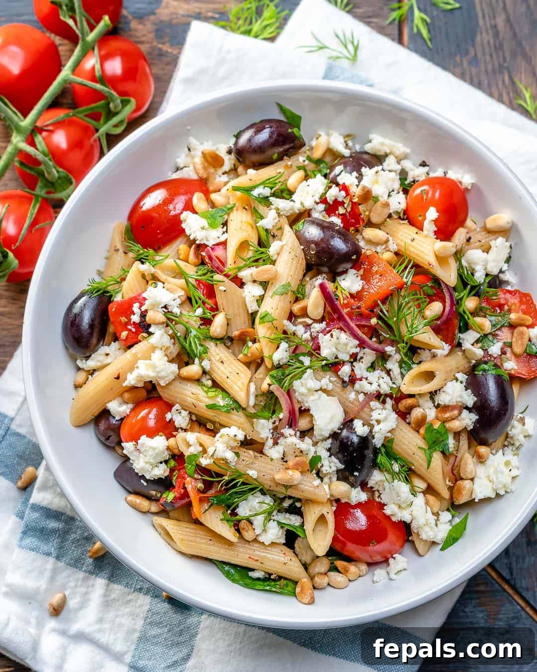 Fresh Greek Cherry Tomato Pasta 7 Close-up of fresh olives, halved cherry tomatoes, and aromatic herbs, key ingredients for Greek pasta