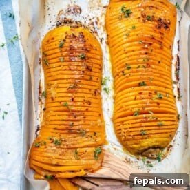 top view of two Hasselback butternut squash on a baking pan