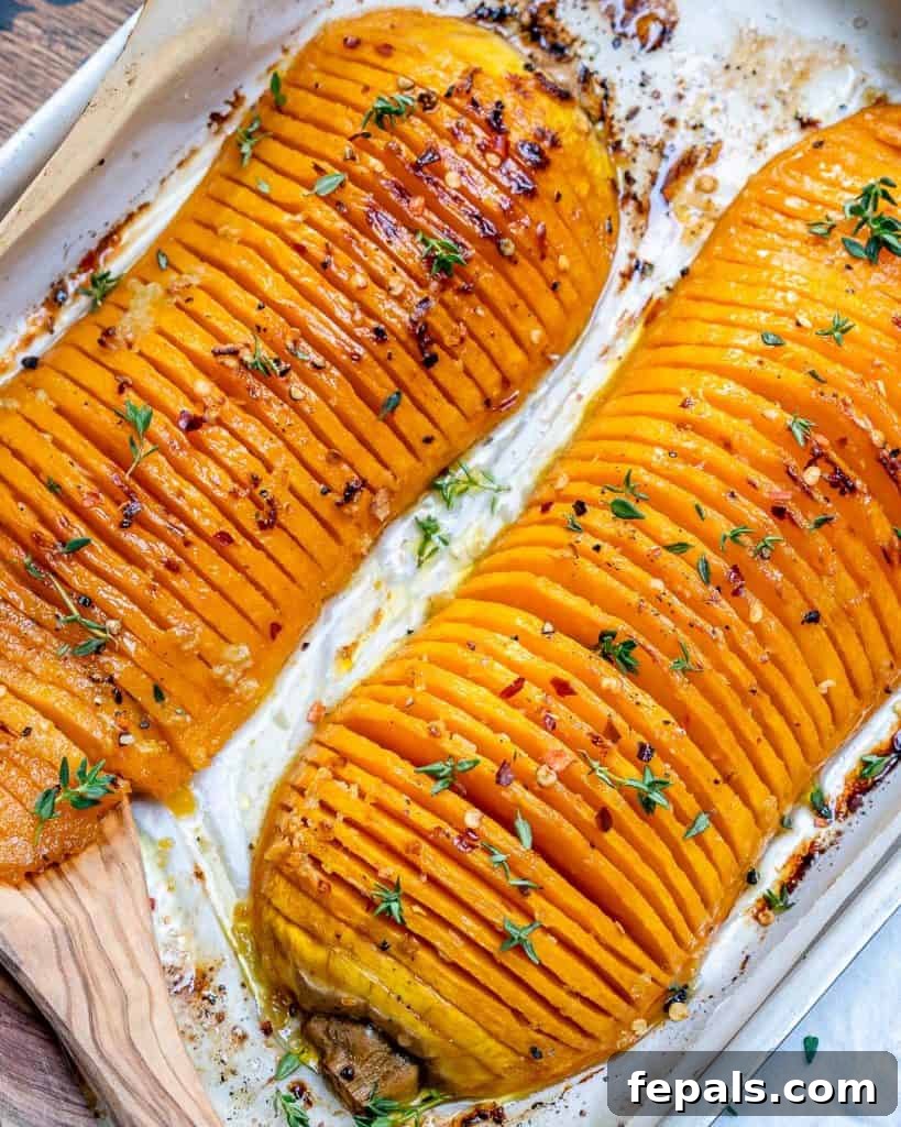 Overhead shot of two Hasselback butternut squash halves ready for the oven.