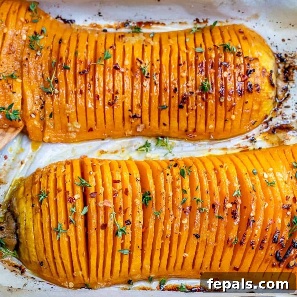 Side view of a perfectly roasted Hasselback butternut squash, golden and tender.