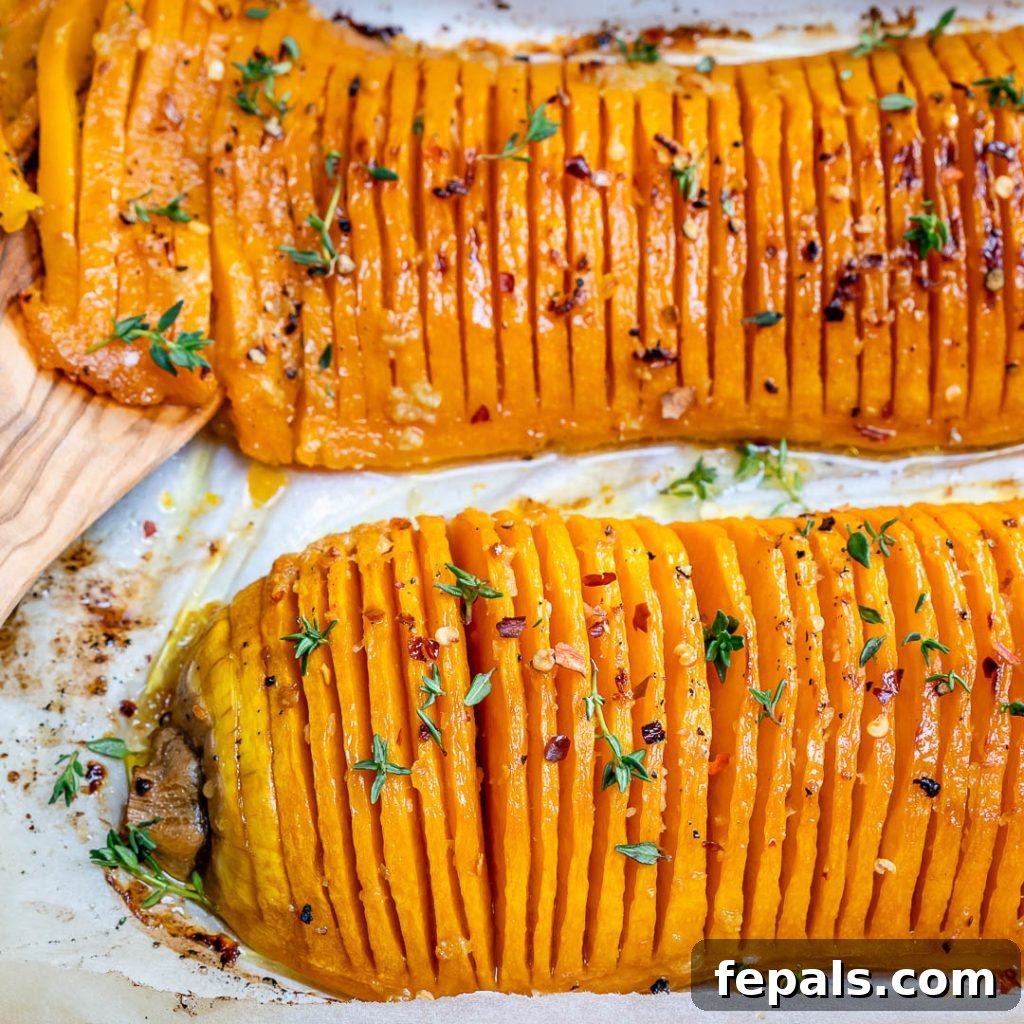 Close-up of a beautifully sliced and roasted butternut squash on a pan, showing the golden edges and tender interior.
