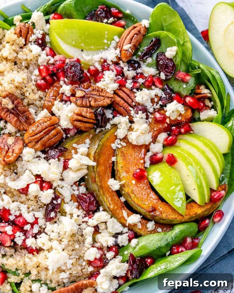 close up view of a loaded harvest quinoa salad in a pristine white bowl, showcasing diverse textures and colors
