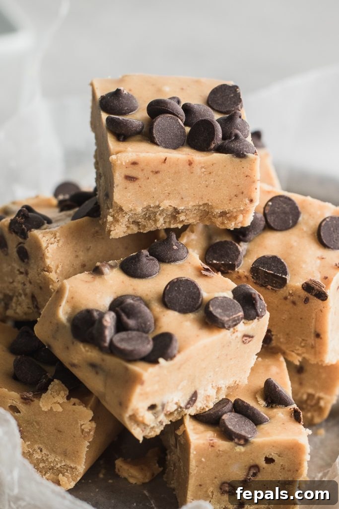 Effortless Chocolate Chip Cookie Dough Fudge 3 Stacks of creamy cookie dough fudge squares, showcasing their perfect shape and inviting texture.