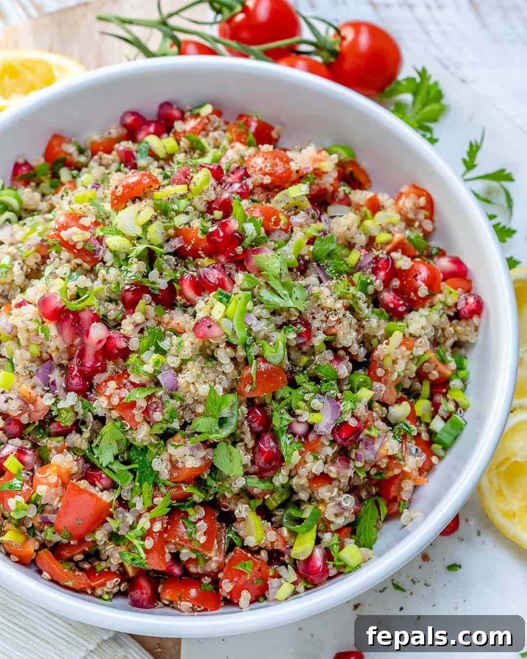 Vibrant Quinoa Tabbouleh Salad 4 Hand mixing a bowl of fresh Quinoa Tabbouleh Salad with a spoon
