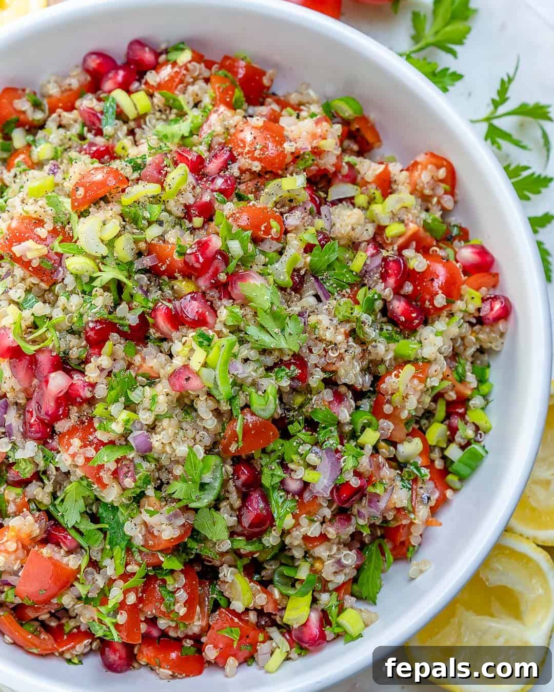 Vibrant Quinoa Tabbouleh Salad 5 A large serving bowl filled with the best Quinoa Tabbouleh Salad recipe, garnished with fresh herbs