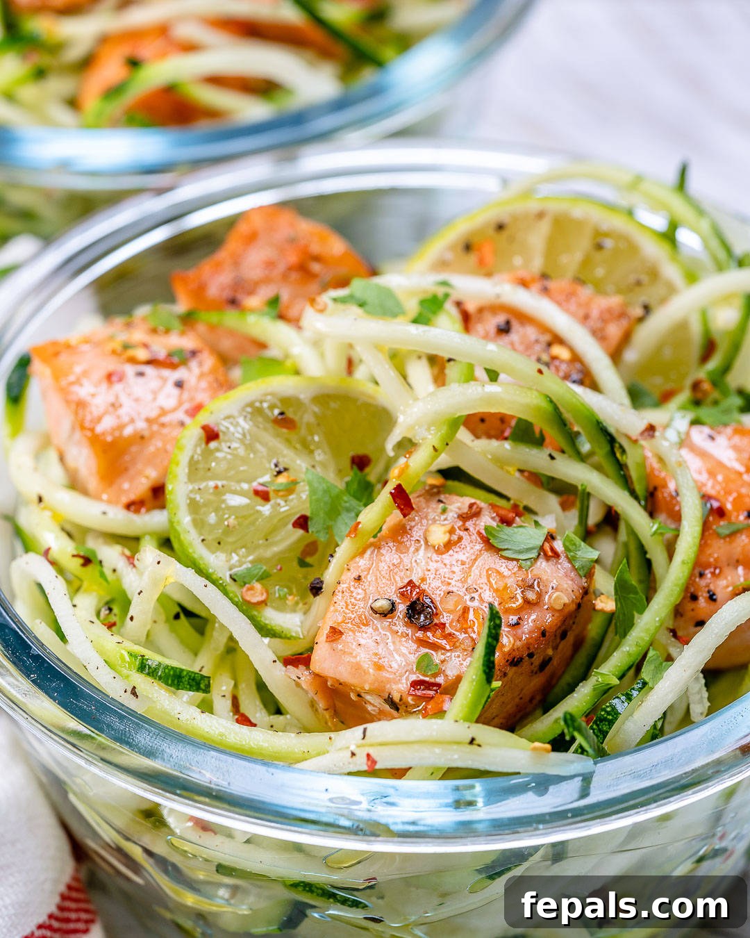 Zesty Chili Salmon Zoodles 2 Close-up shot of perfectly pan-seared chili lime salmon bites in a meal prep container, ready to be enjoyed.