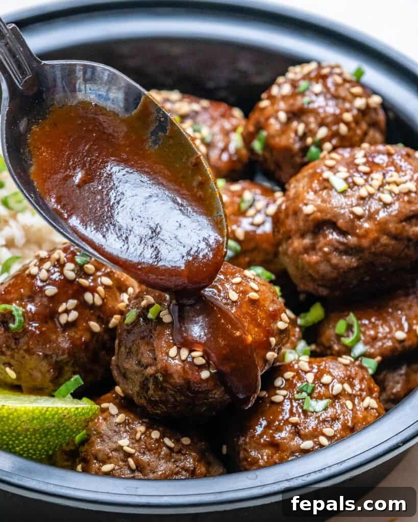 Honey Sriracha Glazed Asian Meatballs 4 spoon pouring Asian Honey Sriracha sauce over meatballs