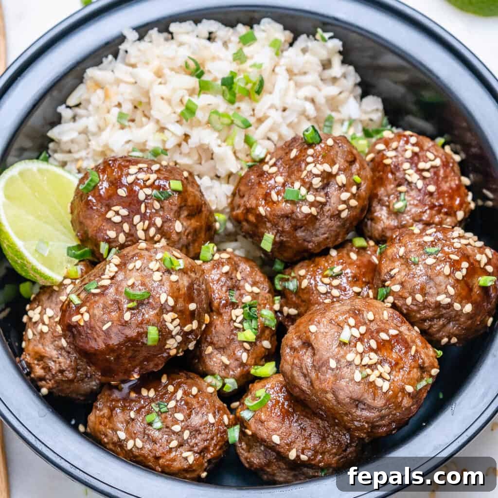 Honey Sriracha Glazed Asian Meatballs 8 side shot of meal prep Honey Sriracha meatballs with rice in a black bowl