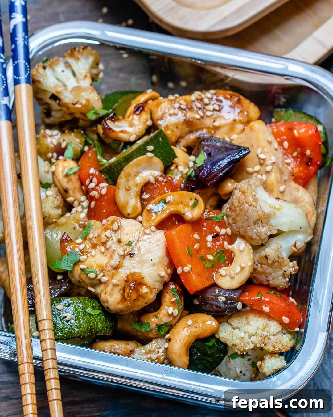 Sheet pan cashew chicken with sauce and garnishes