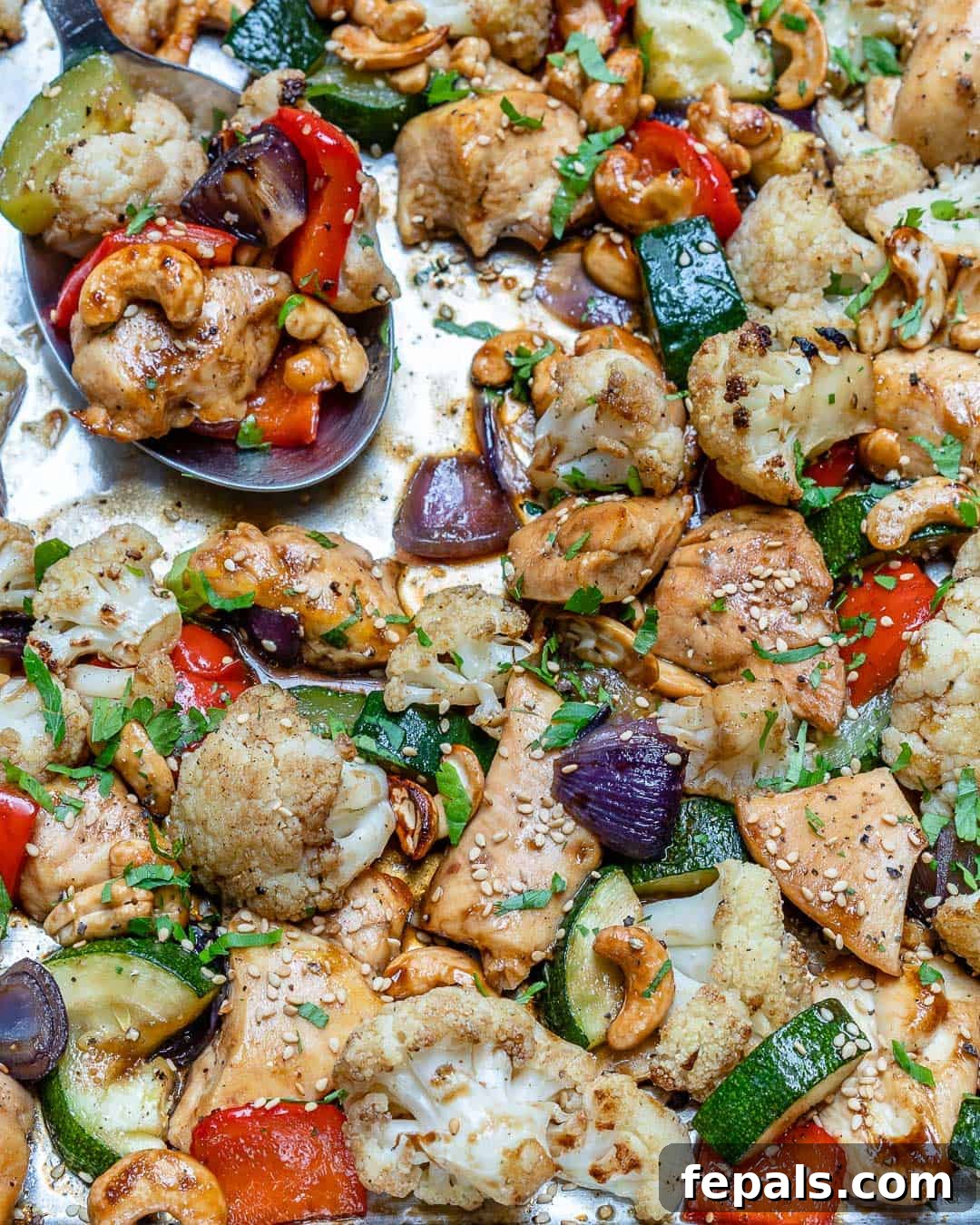 Sheet pan with baked chicken, cashews, and veggies